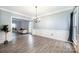 Elegant dining room showcasing crown molding, hardwood floors, and ample space for entertaining at 9238 Heritage Woods Pl, Charlotte, NC 28269