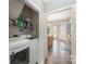 Bright laundry room with washer, dryer, and shelving, leading into the kitchen area at 9238 Heritage Woods Pl, Charlotte, NC 28269
