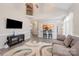 Spacious living room with vaulted ceilings, a modern entertainment center, and comfortable seating at 9238 Heritage Woods Pl, Charlotte, NC 28269