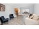 Inviting living room featuring ample seating, large window, and a staircase leading to the upper level at 9238 Heritage Woods Pl, Charlotte, NC 28269