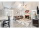 Inviting living room with vaulted ceilings, a cozy fireplace, and large windows for natural light at 9238 Heritage Woods Pl, Charlotte, NC 28269