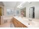 Large main bathroom with double vanity, large mirror, soaking tub, and a separate shower at 9238 Heritage Woods Pl, Charlotte, NC 28269