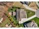 Aerial view of a well-maintained home with a firepit patio, manicured lawn, and large driveway at 1005 Palace Ct # 58, Indian Trail, NC 28079