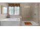 Bathroom featuring a soaking tub, a separate shower, and elegant fixtures for a spa-like experience at 1005 Palace Ct # 58, Indian Trail, NC 28079