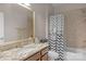 Well-lit bathroom featuring a granite countertop, tile shower and patterned shower curtain at 1005 Palace Ct # 58, Indian Trail, NC 28079