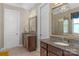 Bathroom featuring dual vanities with granite countertops, framed mirrors, decorative lighting, and tile flooring at 1005 Palace Ct # 58, Indian Trail, NC 28079
