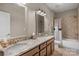 Bathroom with a dual sink vanity, granite countertop, and tiled shower at 1005 Palace Ct # 58, Indian Trail, NC 28079