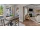 Bright dining area with views to the living room and outdoor deck, featuring hardwood floors and natural light at 1005 Palace Ct # 58, Indian Trail, NC 28079