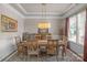 Bright dining room featuring hardwood floors, detailed trim, and a large window, perfect for gatherings and meals at 1005 Palace Ct # 58, Indian Trail, NC 28079