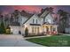 Beautiful two-story home with an attached garage and well-maintained lawn and appealing stone accents at 1005 Palace Ct # 58, Indian Trail, NC 28079