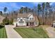 Beautifully landscaped two-story home with a manicured lawn and an inviting red front door at 1005 Palace Ct # 58, Indian Trail, NC 28079