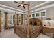 Spacious main bedroom with four-poster bed, tray ceilings, and large windows providing ample natural light at 1005 Palace Ct # 58, Indian Trail, NC 28079