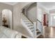 Elegant staircase with white railings and wood treads leads to the upper level, enhancing the home's appeal at 1005 Palace Ct # 58, Indian Trail, NC 28079