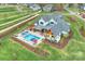 An aerial perspective of a gorgeous house featuring a pool and meticulous landscaping at 101 S Shore Dr, Belmont, NC 28012