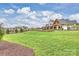 Expansive backyard with lush green grass, landscaping, and a view of the home's exterior at 101 S Shore Dr, Belmont, NC 28012