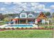 Stunning backyard featuring an outdoor kitchen, spacious patio, and a sparkling pool, perfect for entertaining at 101 S Shore Dr, Belmont, NC 28012