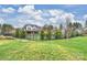 Large fenced backyard with a beautiful lawn and view of the home's architecture at 101 S Shore Dr, Belmont, NC 28012