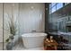 Bathroom features a white soaking tub with stone tile and a window for natural light at 101 S Shore Dr, Belmont, NC 28012