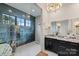 Modern bathroom with granite countertop, chandelier, and blue tile shower at 101 S Shore Dr, Belmont, NC 28012