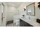 Modern bathroom featuring a glass-enclosed shower and dark vanity with white countertop at 101 S Shore Dr, Belmont, NC 28012
