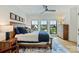 Bright bedroom featuring large windows, hardwood floors, and a comfortable bed with blue accents at 101 S Shore Dr, Belmont, NC 28012