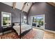Comfortable bedroom with a vaulted ceiling, natural light, and access to a private patio with a hot tub at 101 S Shore Dr, Belmont, NC 28012