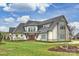An impressive exterior view of a modern farmhouse-style home with a manicured lawn at 101 S Shore Dr, Belmont, NC 28012