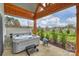 Backyard hot tub under a wooden shelter with view of the lawn and neighborhood at 101 S Shore Dr, Belmont, NC 28012