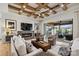 Stunning living room featuring a coffered ceiling, modern fireplace, and sliding glass doors to an outdoor living space at 101 S Shore Dr, Belmont, NC 28012