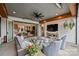 Covered outdoor patio with comfortable seating area, TV, and view to backyard at 101 S Shore Dr, Belmont, NC 28012