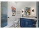 Powder room with blue vanity, patterned tile floor, and decorative wall art at 101 S Shore Dr, Belmont, NC 28012