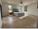 Bright, spacious bedroom with hardwood floors, large windows, and a ceiling fan at 108 Winners Cir # 5, Mooresville, NC 28117