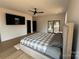 Bright bedroom featuring a ceiling fan, television, and sliding glass doors at 108 Winners Cir # 5, Mooresville, NC 28117