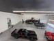 Oversized garage featuring epoxy flooring, multiple cars, a boat, and a helicopter at 108 Winners Cir # 5, Mooresville, NC 28117
