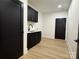 Well-lit laundry room with black cabinetry, white countertops, and sleek design at 108 Winners Cir # 5, Mooresville, NC 28117