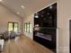 Modern living area with an electric fireplace, dining space, and large windows at 108 Winners Cir # 5, Mooresville, NC 28117