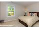 Bedroom with carpeted floor, window and bed with tan colored linens at 116 Asmodean Ln, Troutman, NC 28166