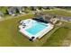 Aerial view of a community pool, featuring a splash pad, a lap pool, and ample seating areas at 116 Asmodean Ln, Troutman, NC 28166