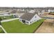 A spacious backyard with an screened-in porch complements this white home in a neighborhood setting at 1205 Brooksland Pl, Waxhaw, NC 28173