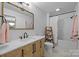 Stylish bathroom with herringbone vanity, gold mirror, and modern fixtures, with tiled floors at 1205 Brooksland Pl, Waxhaw, NC 28173