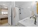 Bright bathroom showcasing marble walls, black fixtures, and a glimpse into an adjacent bedroom at 1205 Brooksland Pl, Waxhaw, NC 28173