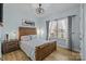 Bright bedroom with blue walls featuring a wood bed frame, a large window and wood floors at 1205 Brooksland Pl, Waxhaw, NC 28173