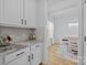 Bright kitchen with white cabinets, granite countertop, a mosaic backsplash, and eat-in breakfast area at 1205 Brooksland Pl, Waxhaw, NC 28173