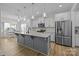 Bright kitchen featuring granite countertops, white cabinets, stainless steel appliances, and an island at 1205 Brooksland Pl, Waxhaw, NC 28173