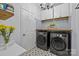 Well-organized laundry room featuring modern appliances, stylish tile flooring, and ample counter space at 1205 Brooksland Pl, Waxhaw, NC 28173