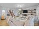 Spacious living area featuring stylish decor, fireplace, built-ins, a modern TV, and comfortable seating at 1205 Brooksland Pl, Waxhaw, NC 28173