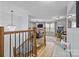 Open-concept living space with hardwood floors, a staircase, and a combined seating and play area at 1205 Brooksland Pl, Waxhaw, NC 28173