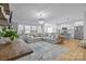 Inviting living space with hardwood floors, modern lighting, comfortable seating, and an open-concept kitchen at 1205 Brooksland Pl, Waxhaw, NC 28173