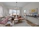 Cozy living room with lots of sunlight featuring a decorative chandelier, artwork and stylish furniture at 1205 Brooksland Pl, Waxhaw, NC 28173