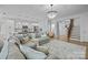Open-concept living space with modern kitchen, hardwood floors, and staircase with wooden banister at 1205 Brooksland Pl, Waxhaw, NC 28173